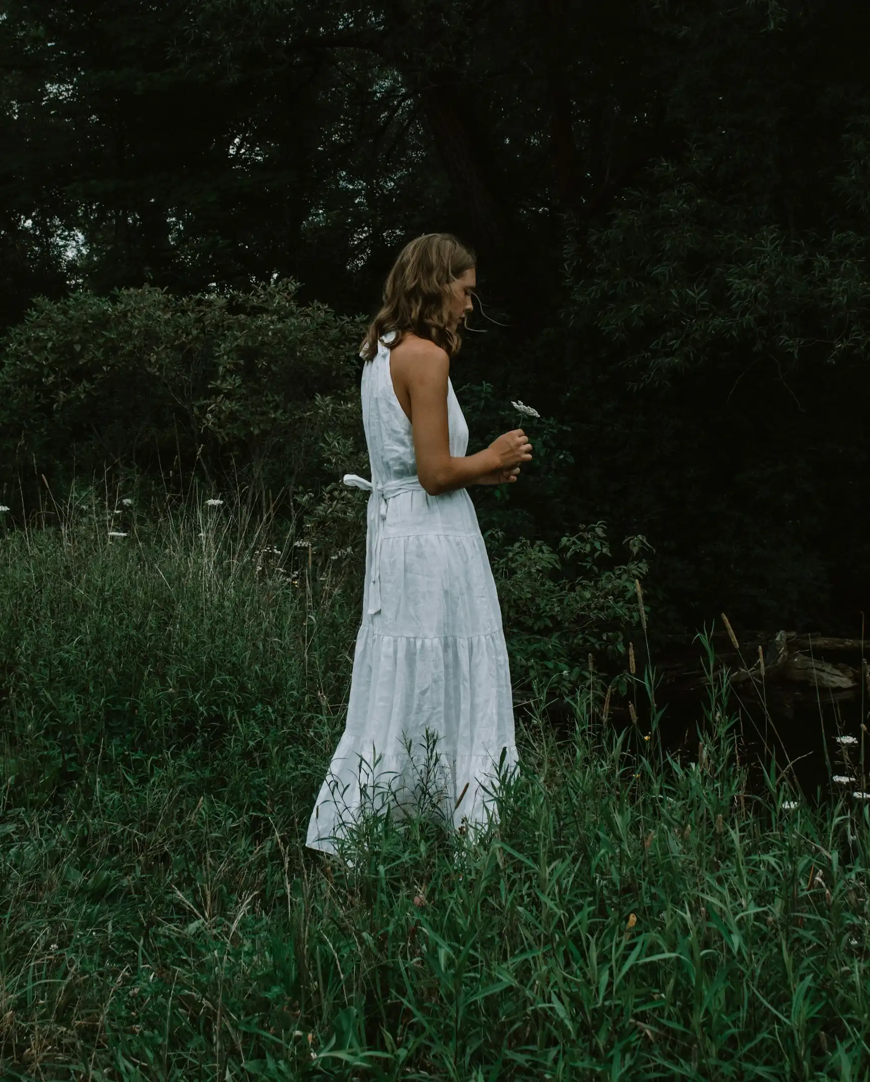 Woman in white dress by greenery | ARTH